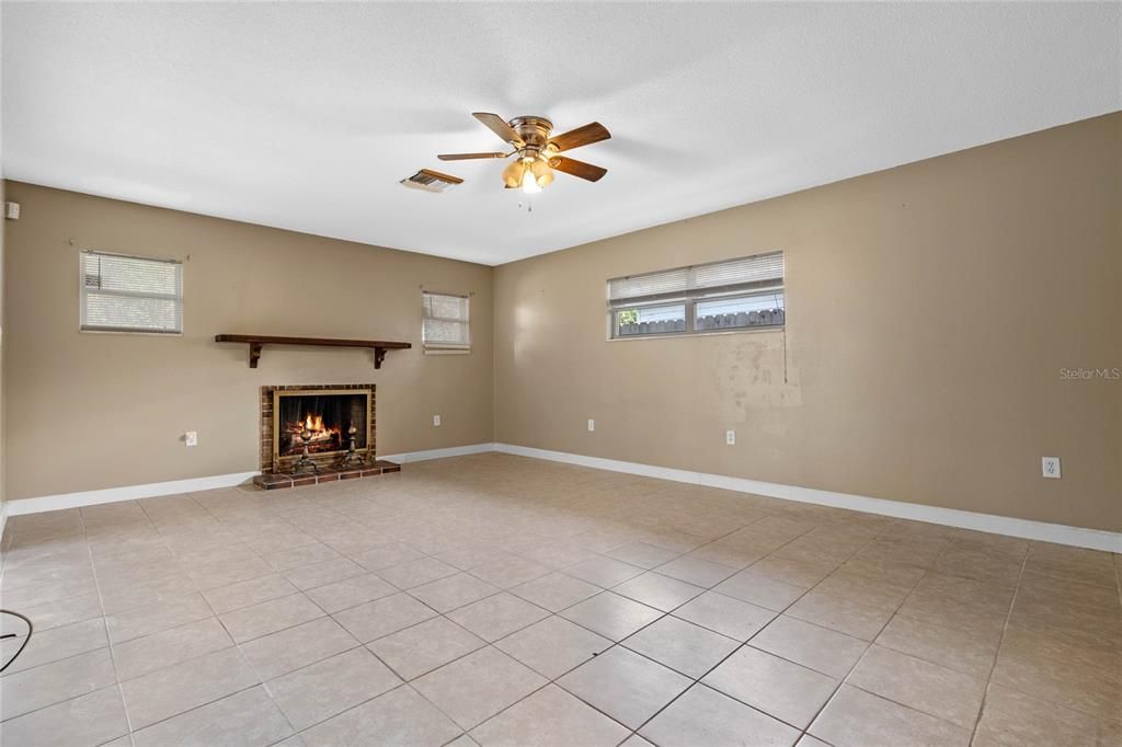 Master bedroom with fireplace and sliders out to the pool area.