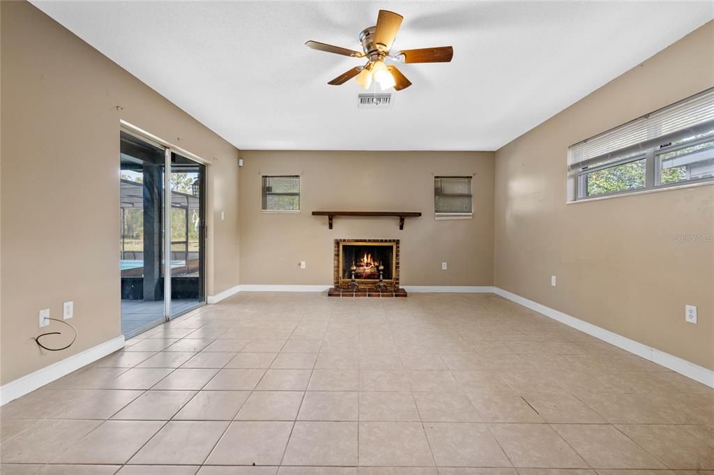 Master bedroom with fireplace and sliders out to the pool area.