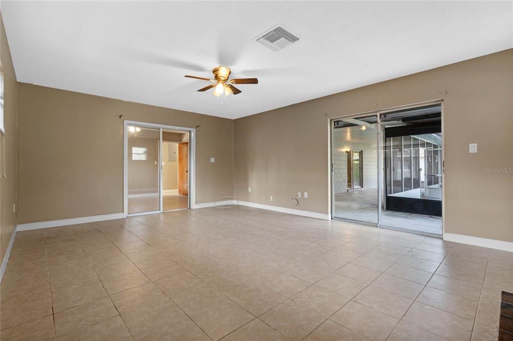 Master bedroom with fireplace to the right and sliders out to the pool area. Slider in center of picture leads to Master bedroom Den/office.