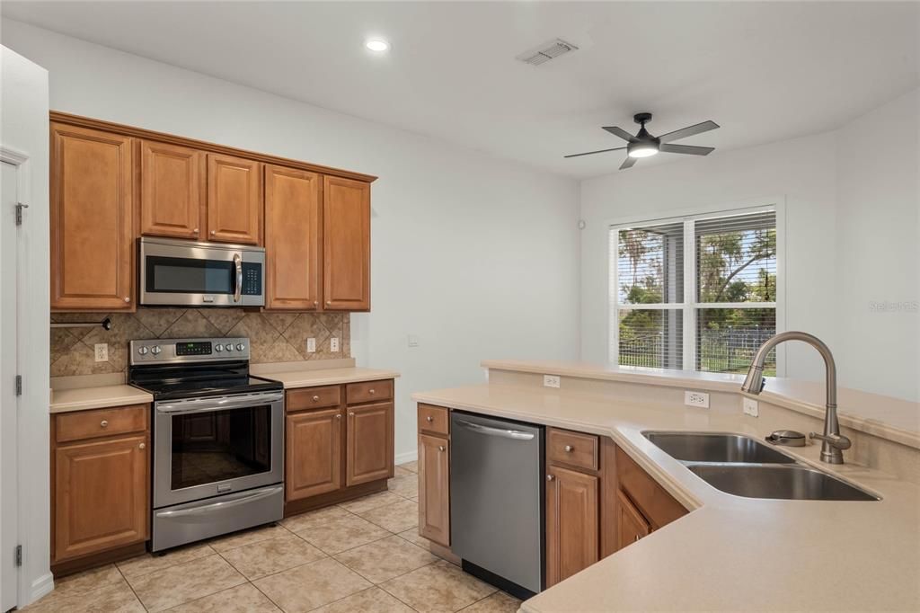 kitchen features ample cabinetry, Corian countertops