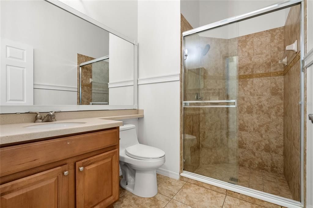 second bathroom with glass-enclosed shower