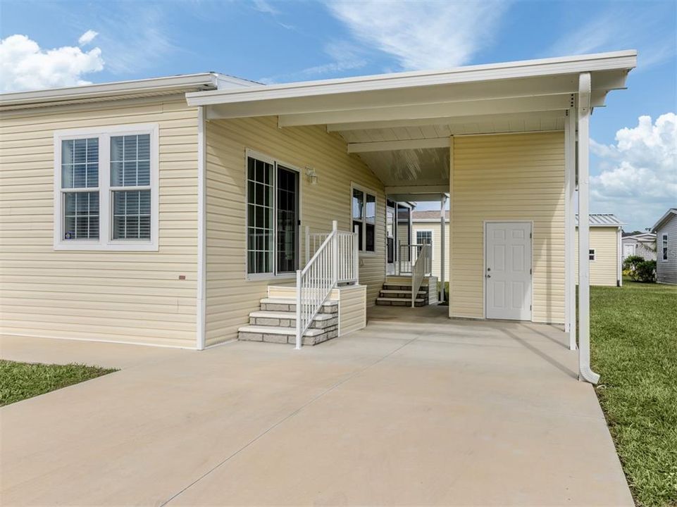 Covered entry, covered carport, storage shed and enclosed lanai