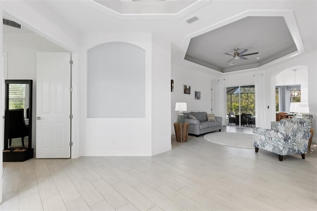 Open floor plan looking in from the front door out into the beautiful pool and large backyard beautifully landscaped