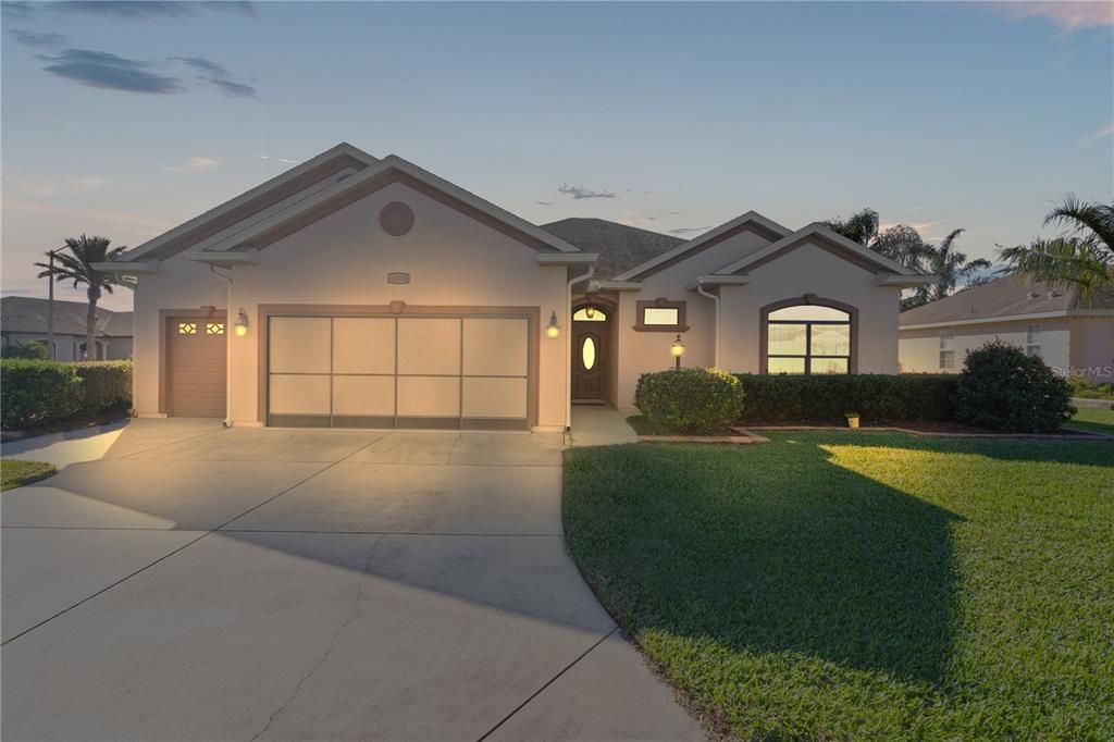 FRONT EXTERIOR, EVENING, LOVELY CORNER LOT AND POOL.