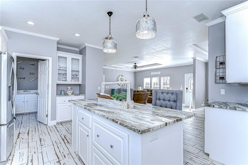 Large granite island features a breakfast bar with ample room!