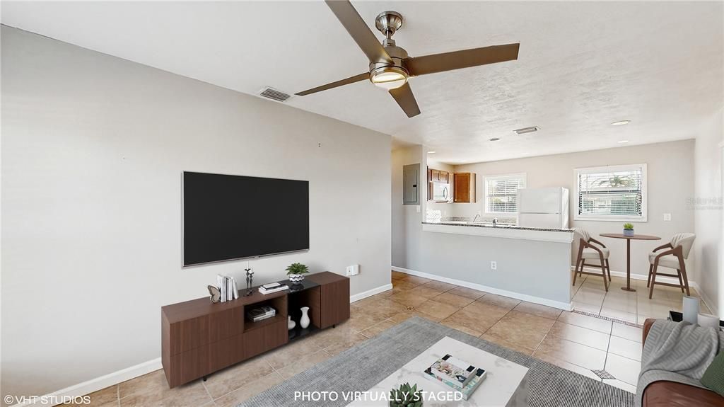 Photo virtually staged - Living room w/ partial of Kitchen