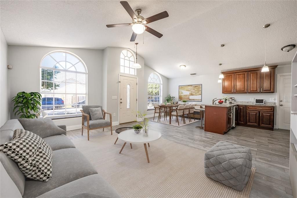 Step through the front door and into your open living, dining and kitchen under a VAULTED CEILING with endless natural light and modern tile floors that compliment the UPDATED KITCHEN, giving you a great space to gather with family or entertain friends. Virtually Staged.