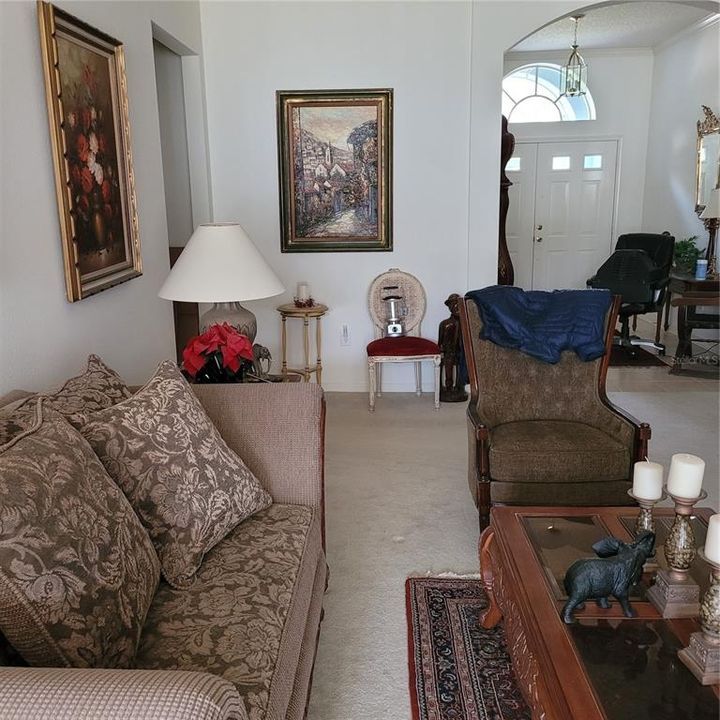 From the living room looking towards the front door, you see that it has double doors and a wide entry.  The foyer is of tile flooring.