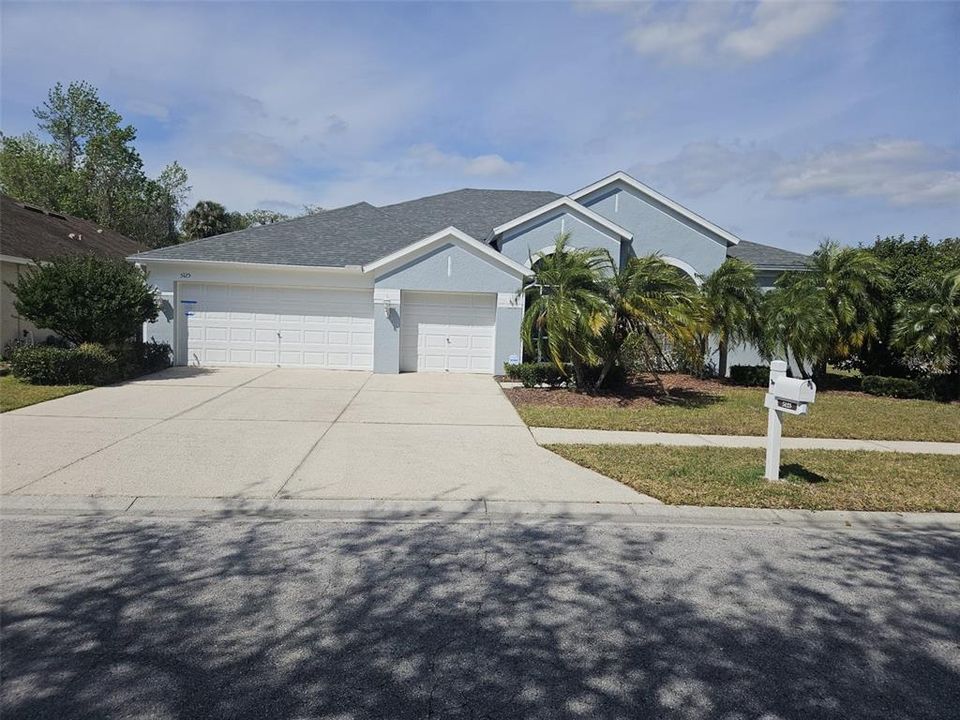 Front view.  Three car garage.  The plants on the front of the door give some added privacy.  The front has the coach lights for added security at night.