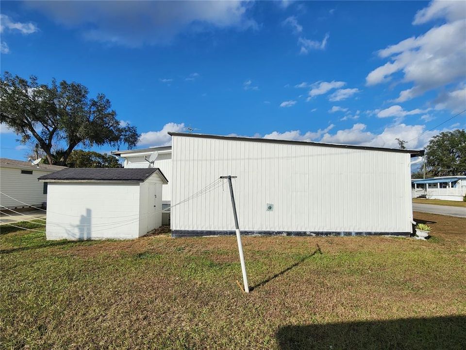 Attached garage & cement block storage building.