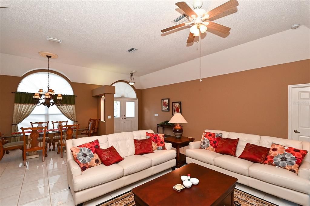 Living Room with view to the front door and Dining Room