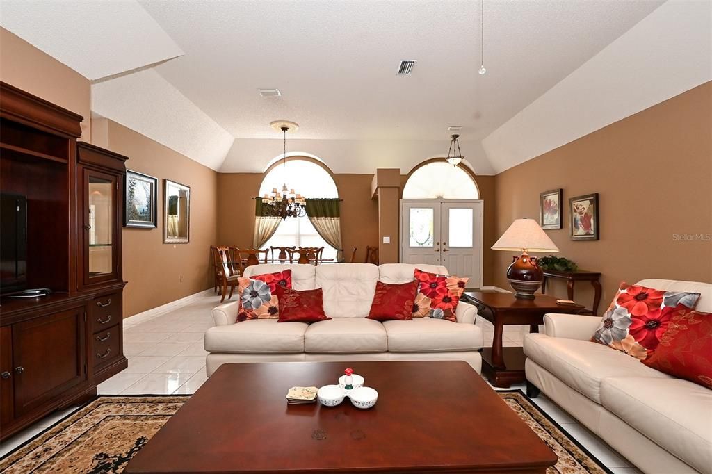 Living Room with view to front door and Dining Room