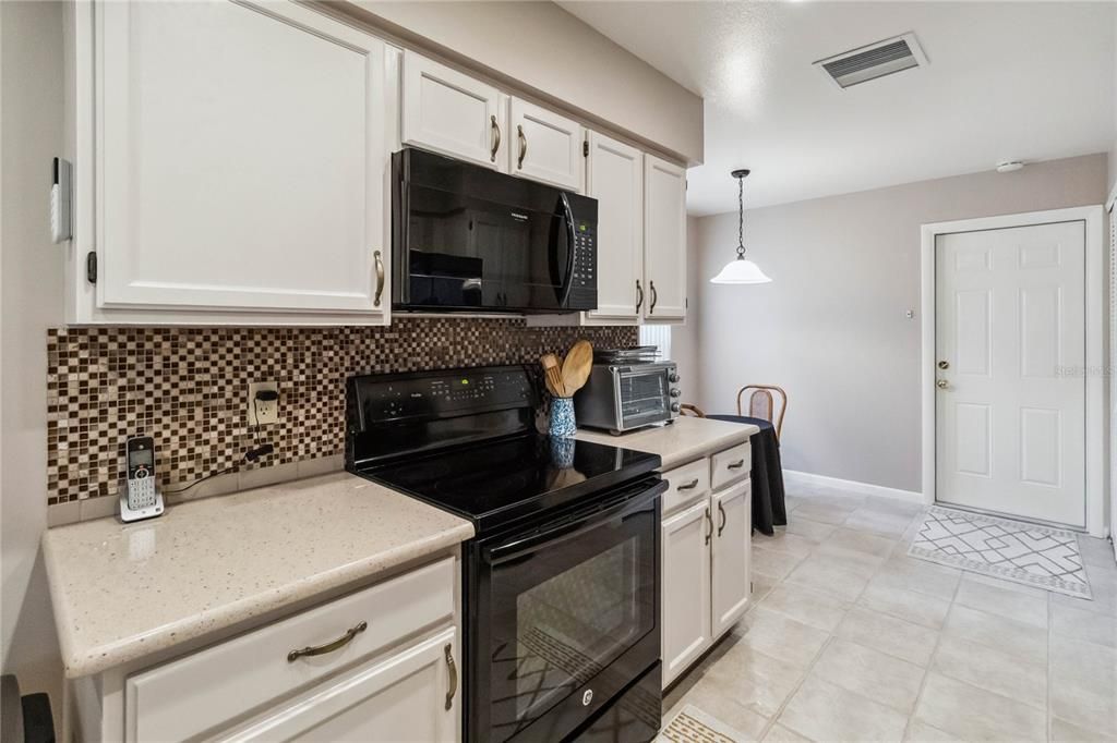 White Cabinets and tile flooring.