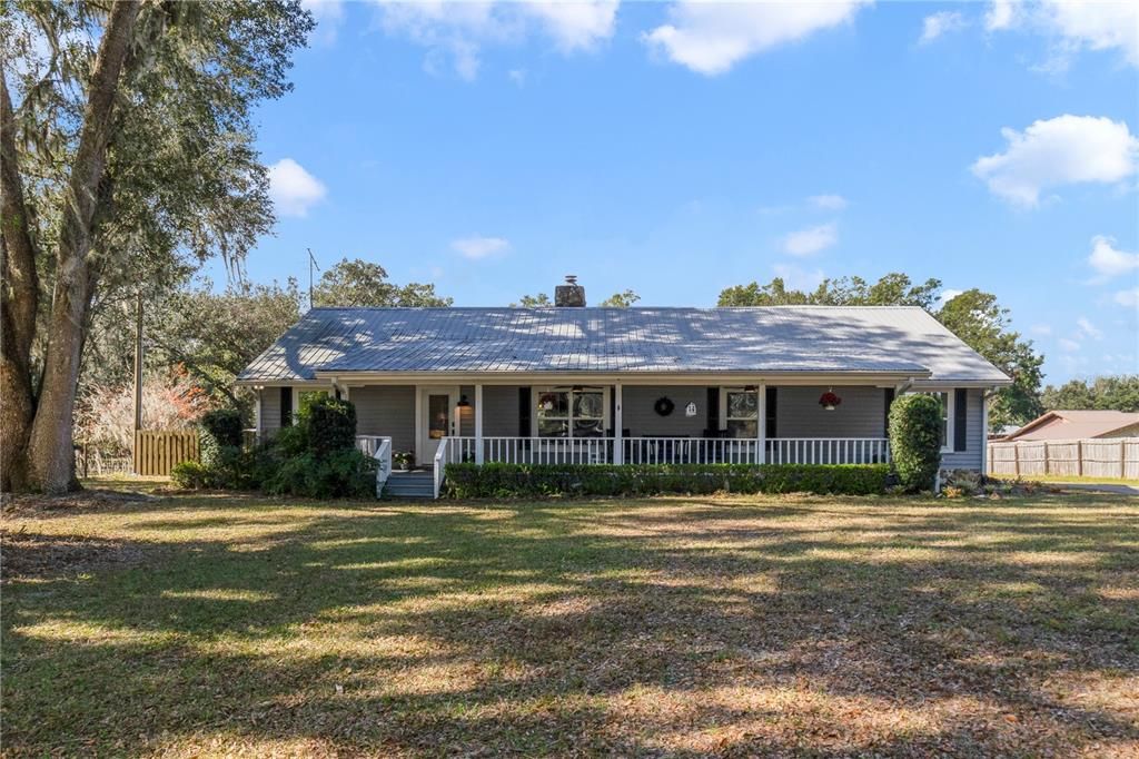 Charming front porch running the entire length of the home