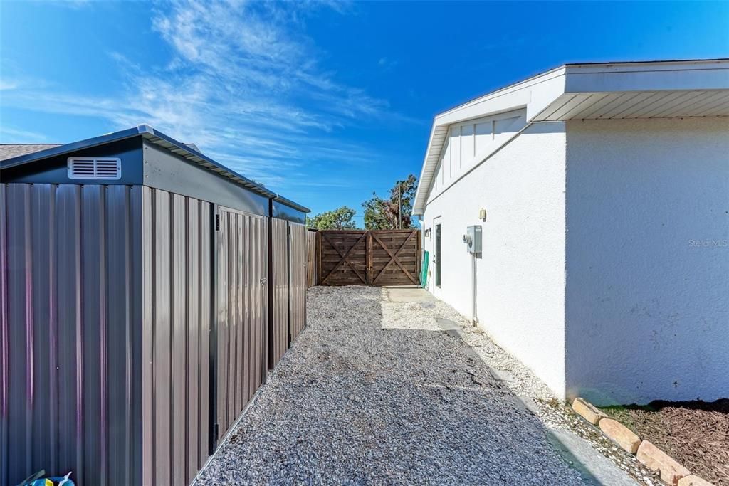 Boat or RV storage on side of house with double gate.