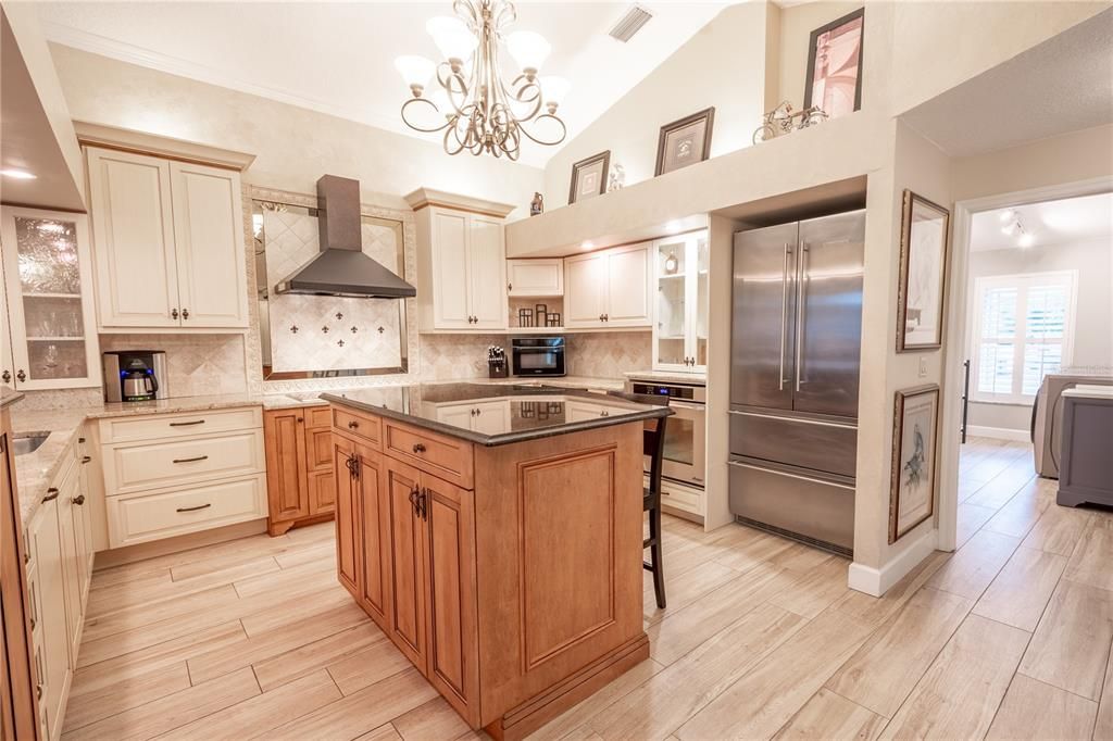 High-end stainless steel appliances include a French door Liebherr refrigerator, Dacor built-in oven, multi-burner Wolf glass cooktop stylish exhaust hood, and a Brew Express plumbed in coffee-maker.