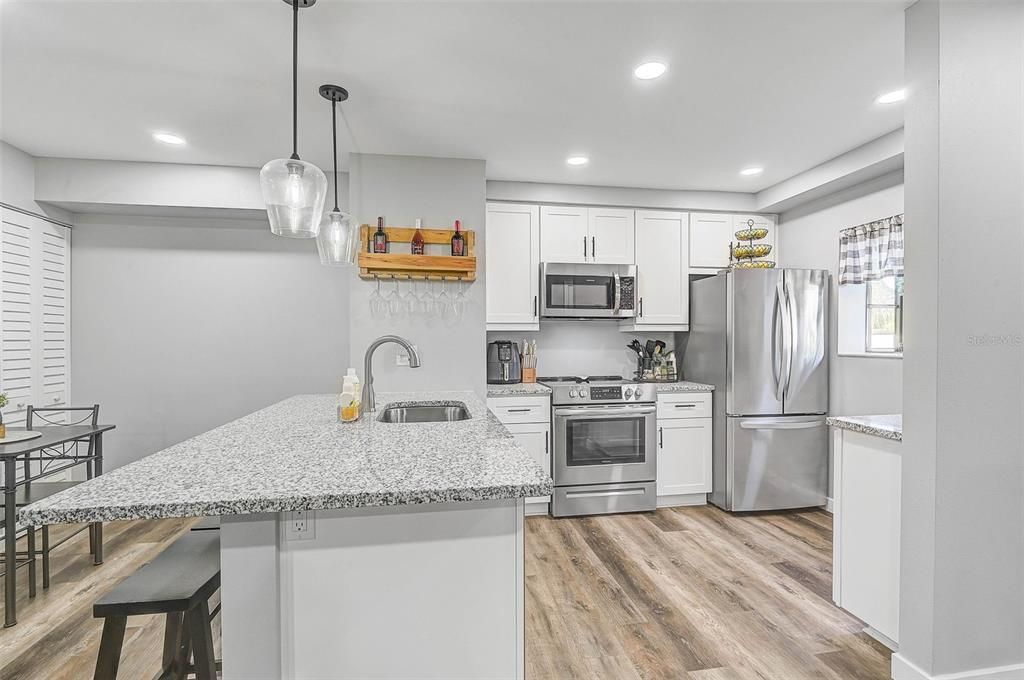 This kitchen features brand new appliances, custom cabinetry, and sleek luxury vinyl plank floors, creating a modern and inviting space!