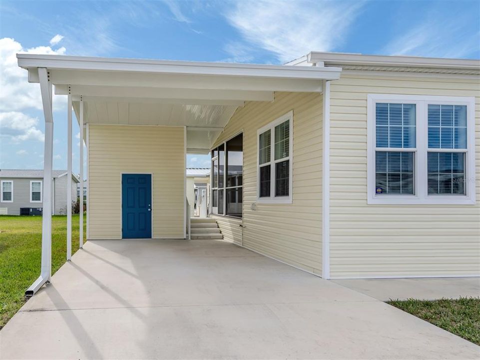 Covered carport, storage shed and entrance to back porch