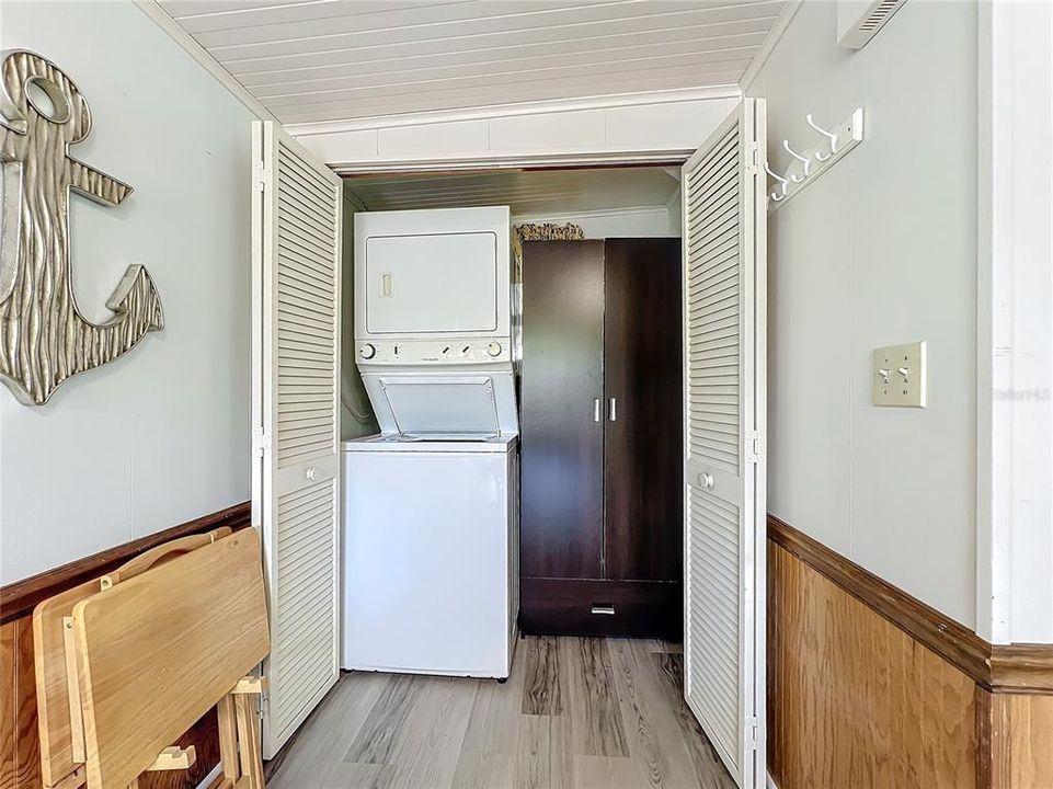 Utilty closet with stackable washer and dryer.