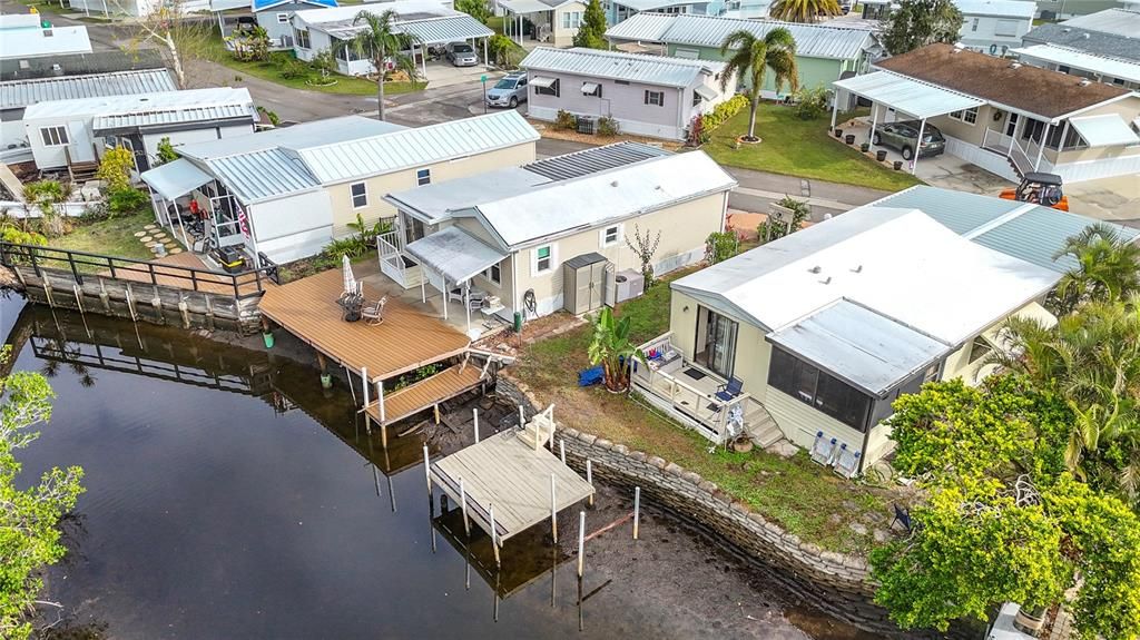 Best of all worlds with this updated home, new roof, impact windows, and boatable water.