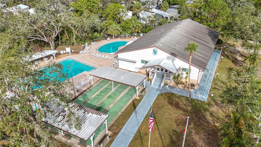 Another view of the two pools shuffeboard courts, and clubhouse.