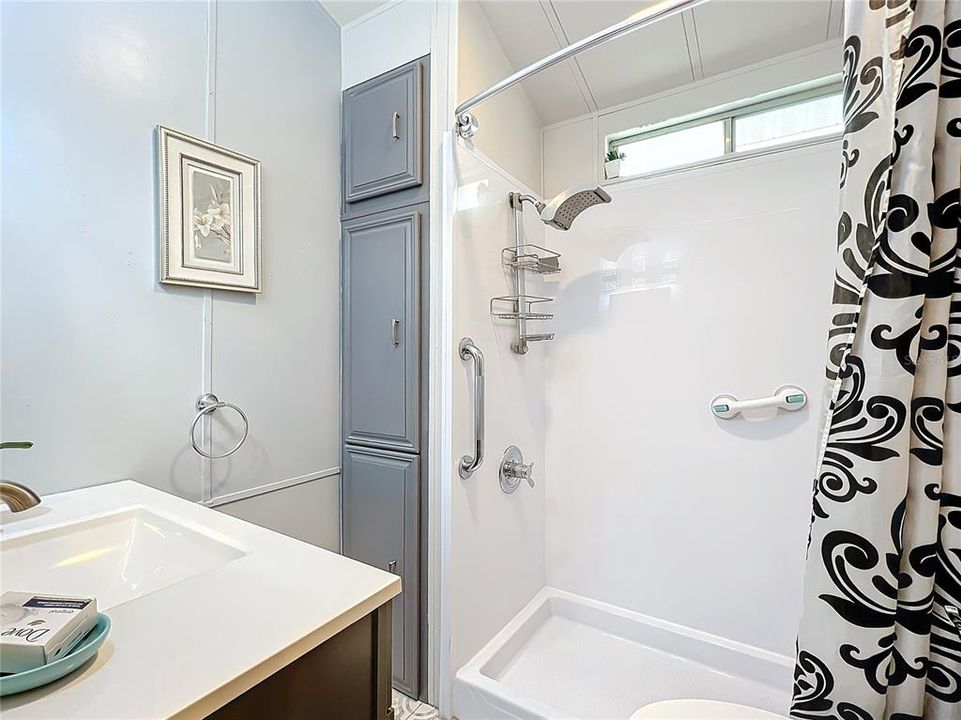 Renovated bathroom with grab bars for safety and peace of mind.  Check out the shower head!