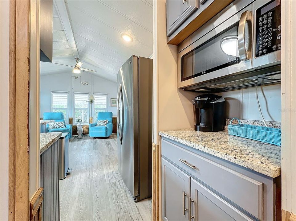 Microwave above the additional countertop and cabinet space.