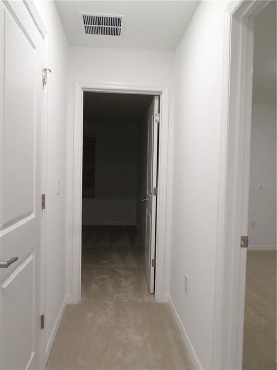 Hallway to linen closet and 2nd Bedroom