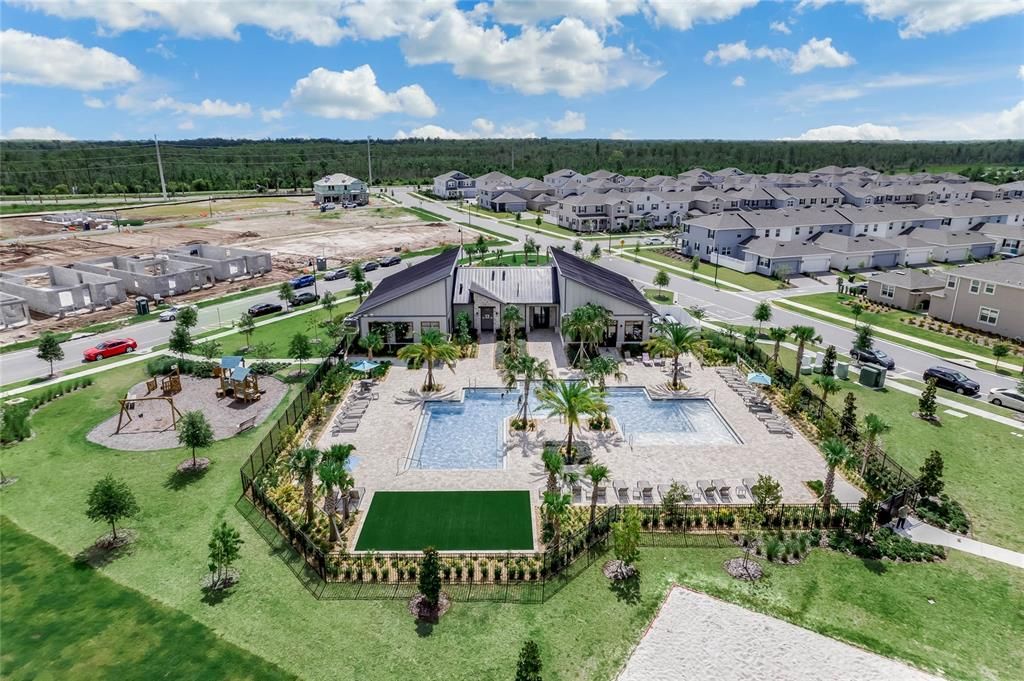 Clubhouse 2 with view of resort pool 2, playground 2, sand volley ball court.