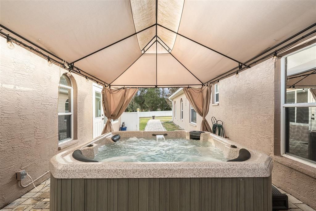 Hot Tub Area off of Laundry Room with Walkway to Pool Area