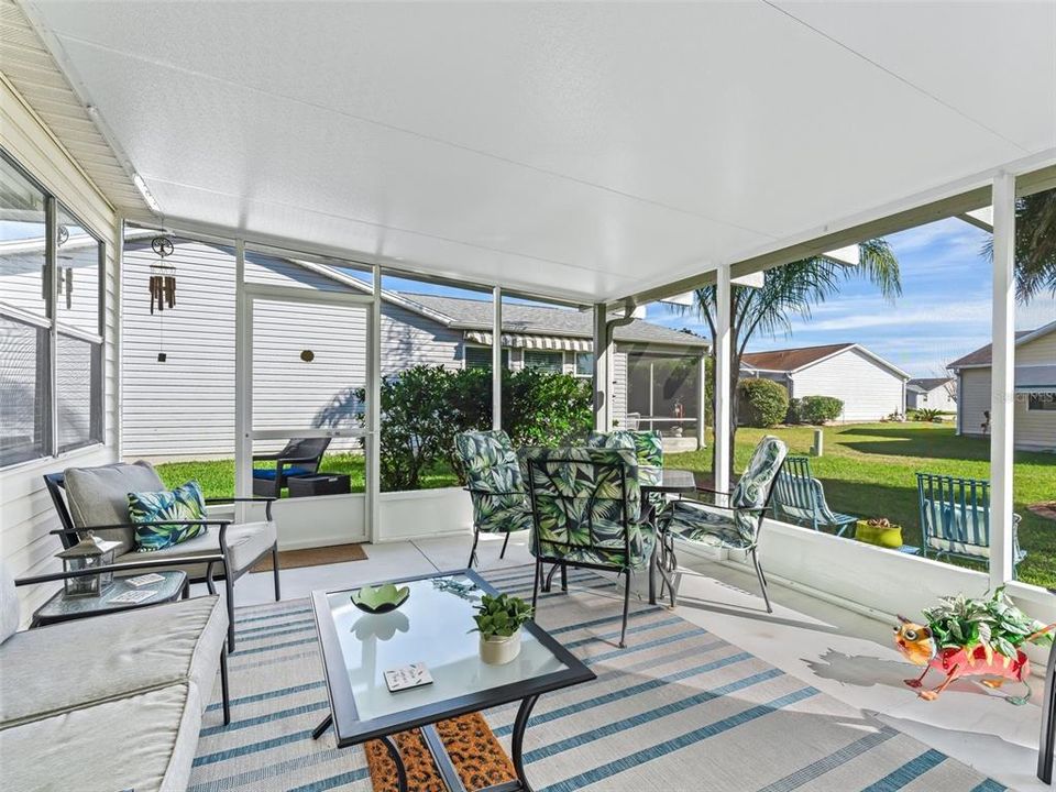 Large screened lanai with a spacious EAST FACING rear, EXTRA GRILLING/SITTING area beyond ON BOTH SIDES.