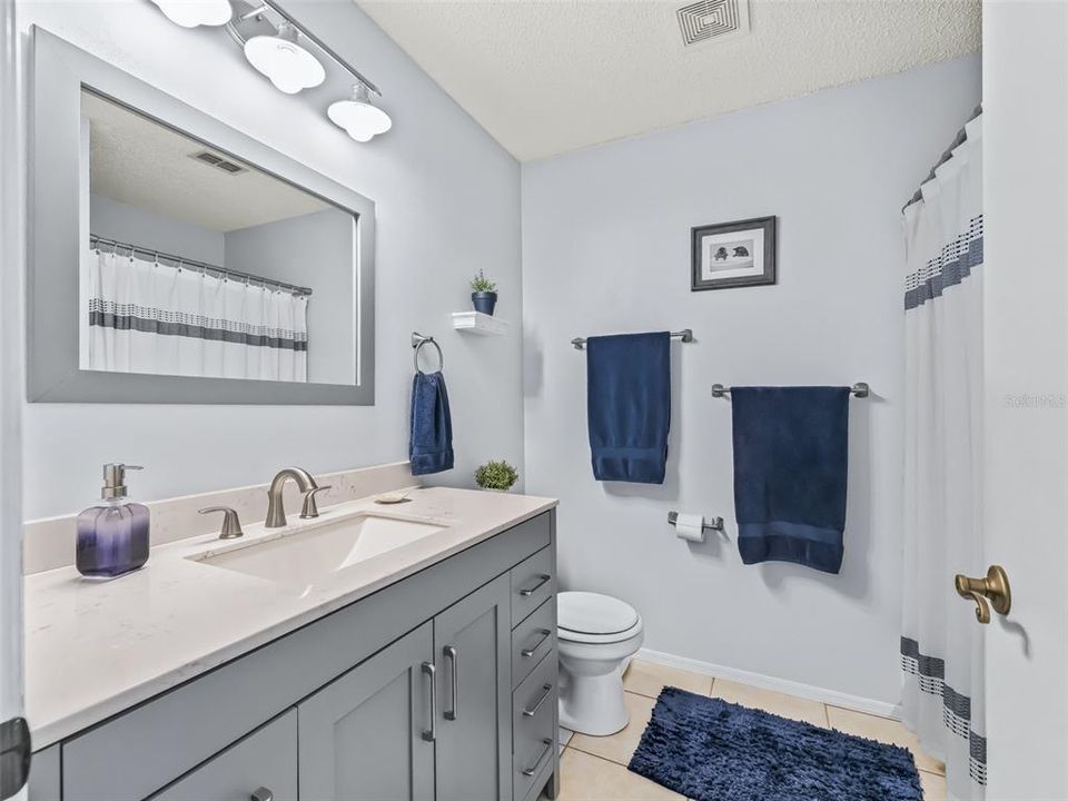 NEW Vanity with square sink and walk-in shower! An abundance of cabinet and drawer space.