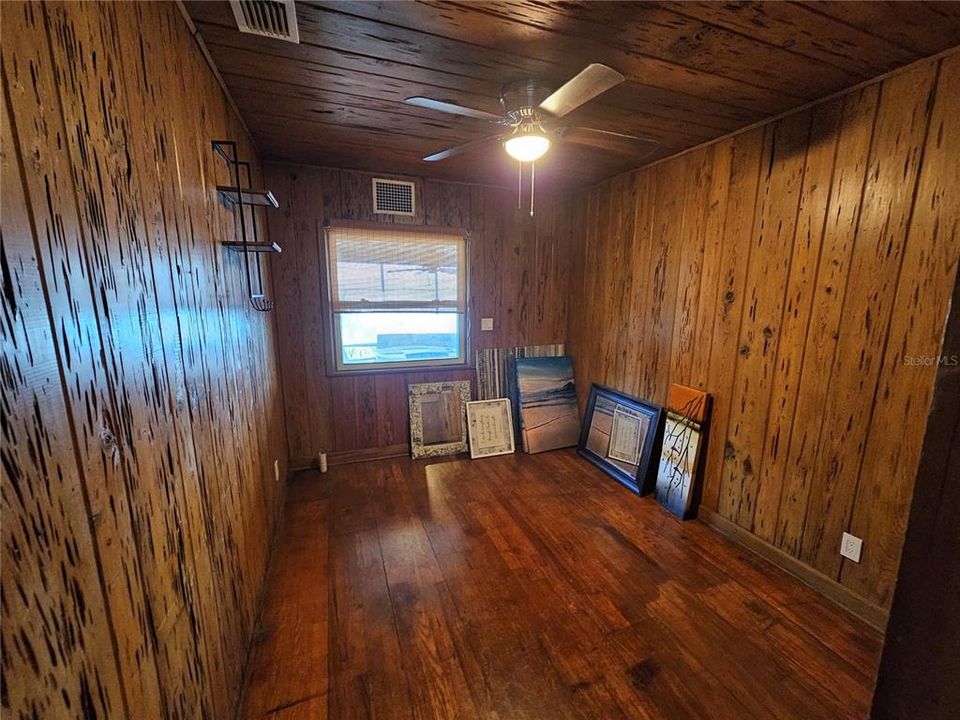 Bedroom #2 w/Knotty Cypress Wood Paneling.