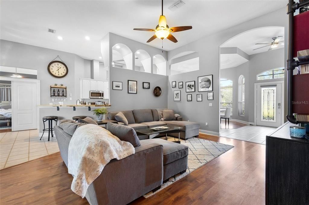 Main living area. Kitchen/dining areas at left, front entrance to right.