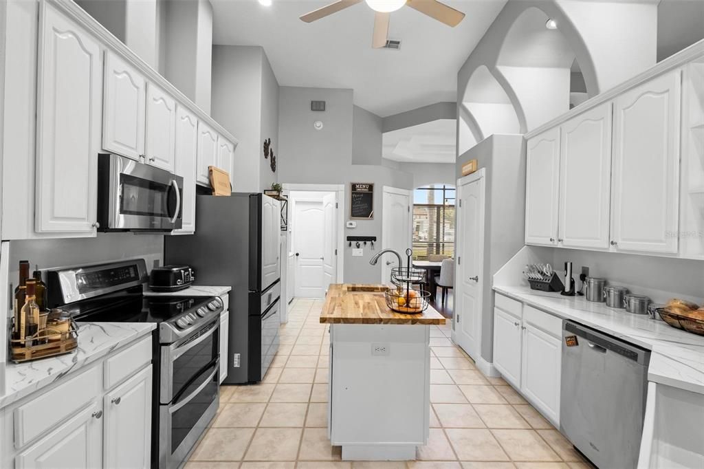 The upgraded kitchen features gorgeous granite, 42" cabinets, two pantries, and a double oven.