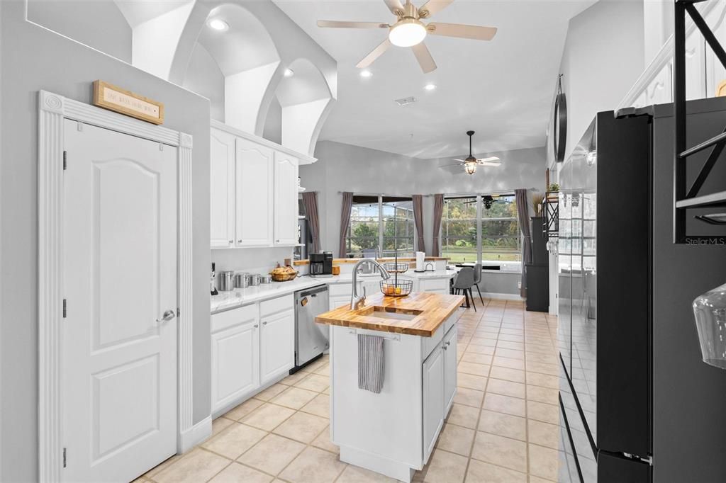 Kitchen towards informal dining and pool area afar.