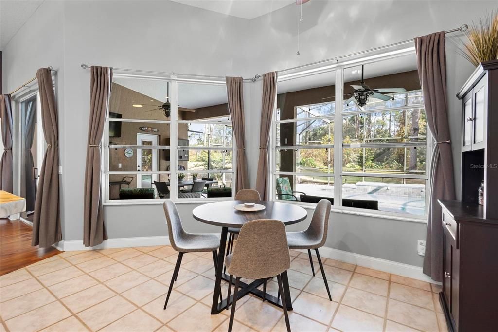 Eat-in dining area adjacent to kitchen and living area overlooks the lanai and pool area.