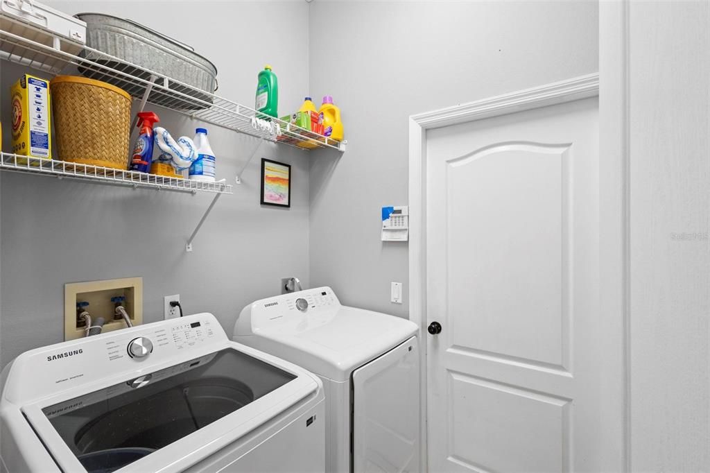 The utility room includes a utility sink (not shown) and the washer and dryer could stay with your new home.