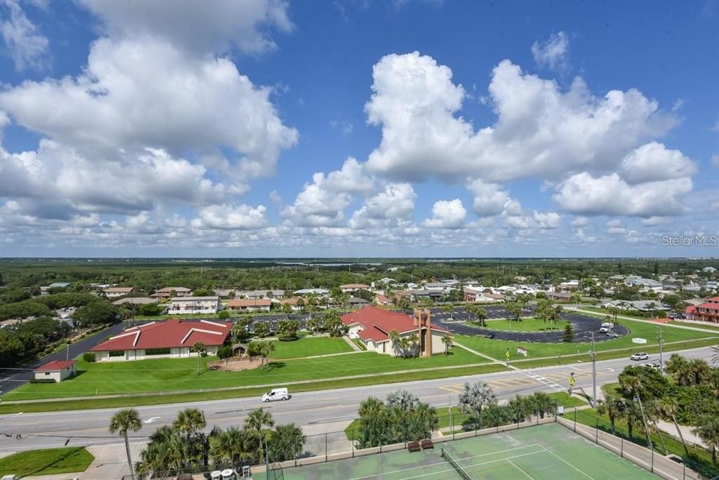 Expansive views of the serene neighborhood and lush greenery from the 5th floor, offering a peaceful retreat just steps away from the beach.