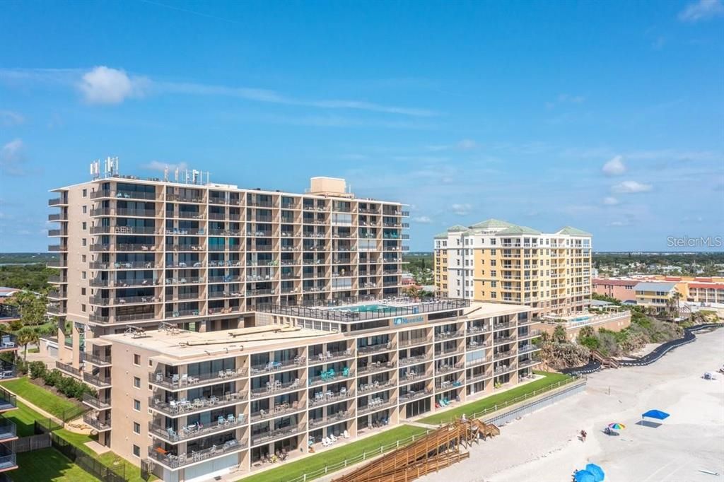 Stunning rooftop pool offering panoramic ocean views, perfect for relaxing or entertaining in a resort-style setting.