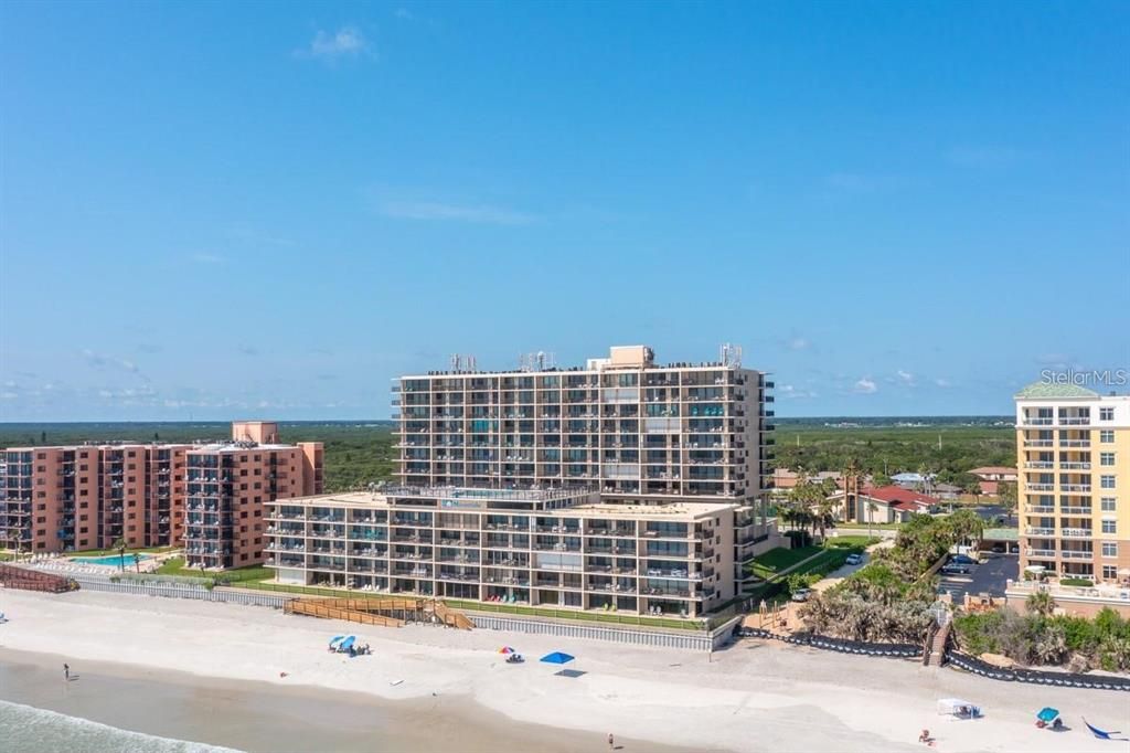 Beachfront condominium building with direct ocean access, offering resort-style amenities and breathtaking coastal views.