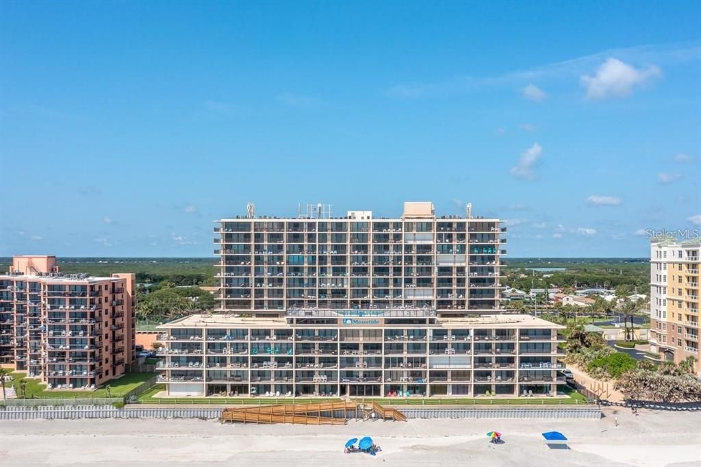 Beachfront condominium building with direct ocean access, offering resort-style amenities and breathtaking coastal views.