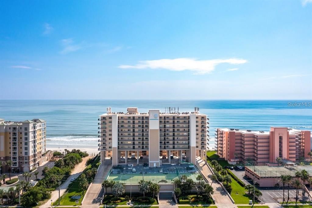 Beachfront condominium building with direct ocean access, offering resort-style amenities and breathtaking coastal views.