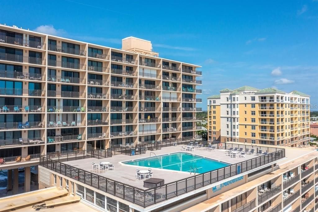 Stunning rooftop pool offering panoramic ocean views, perfect for relaxing or entertaining in a resort-style setting.