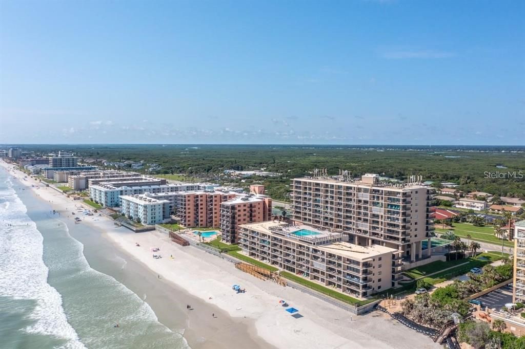 Beachfront condominium building with direct ocean access, offering resort-style amenities and breathtaking coastal views.