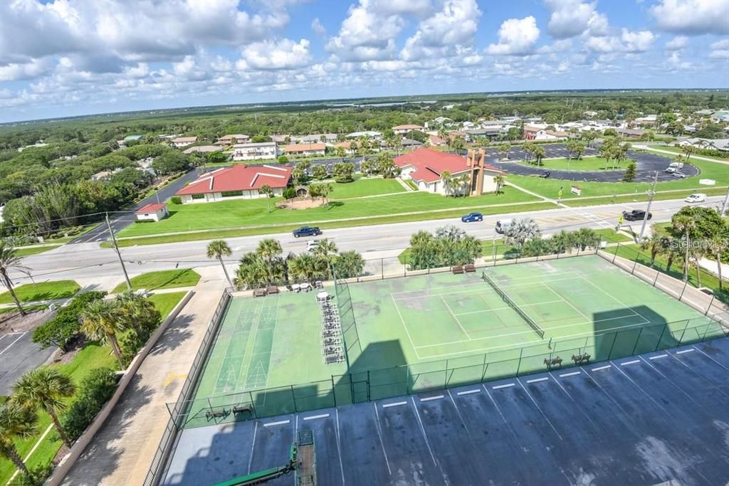 Expansive views of the serene neighborhood and lush greenery from the 5th floor, offering a peaceful retreat just steps away from the beach.