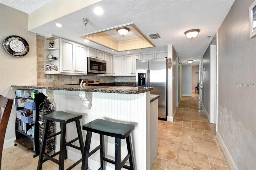 Beautifully upgraded kitchen with granite countertops, stainless steel appliances, and elegant cabinetry, perfect for any home chef.