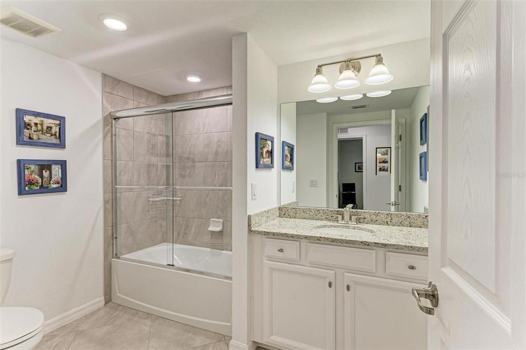 2nd bathroom features a shower tub combo and is easy access to/from the garage and laundry room