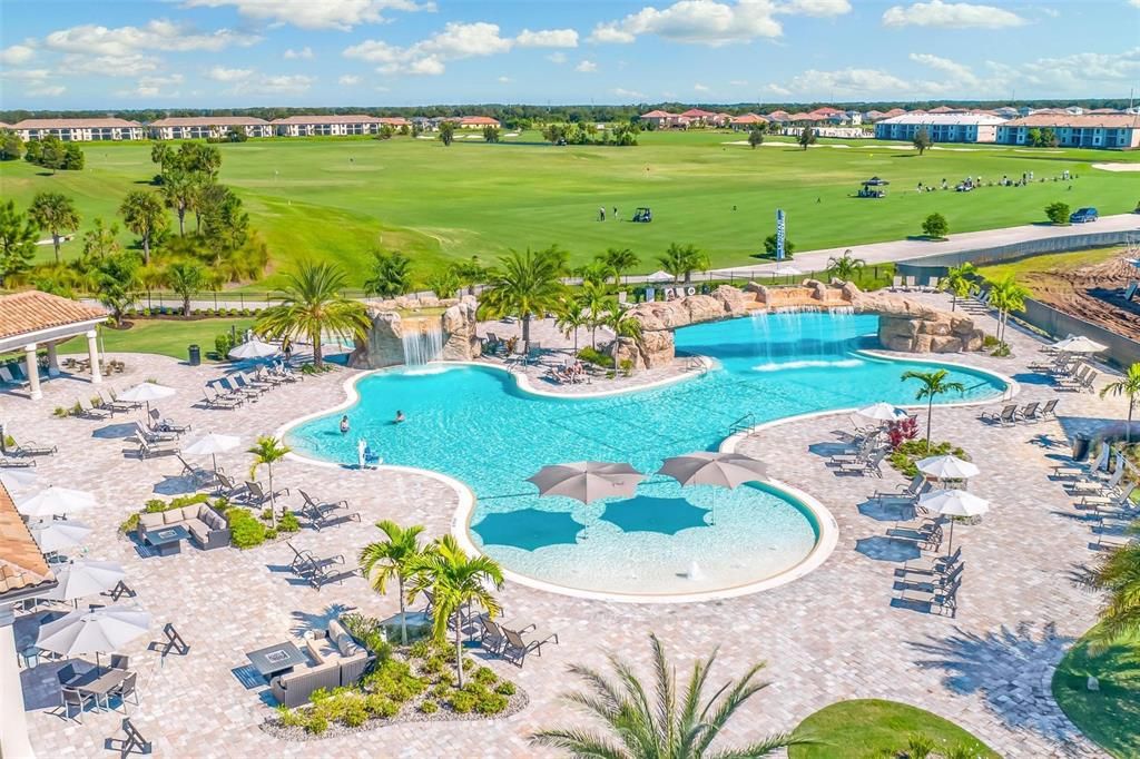 Community Pool with zero entry and Resort Style Waterfall and Golf Course beyond