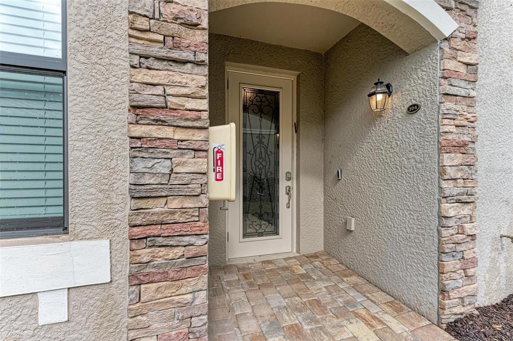 Gorgeous covered front entryway with glass accent front door, Ring Door Bell system, power outlet for holiday lighting and fire extinguisher handy in case of unwanted emergencies.